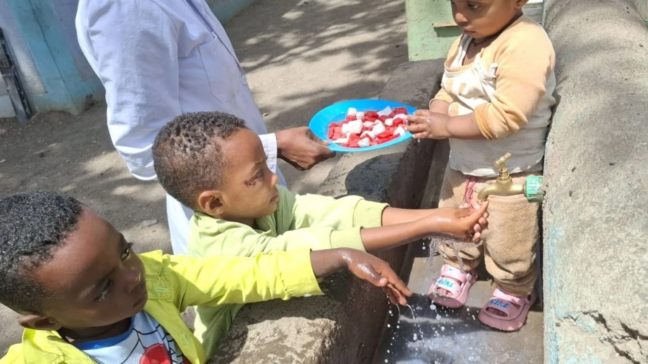 Children in the Day-care center washing their hands with soap before their lunch.